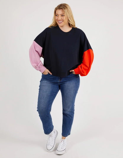 women wearing blue denim jeans and a colour block jumper